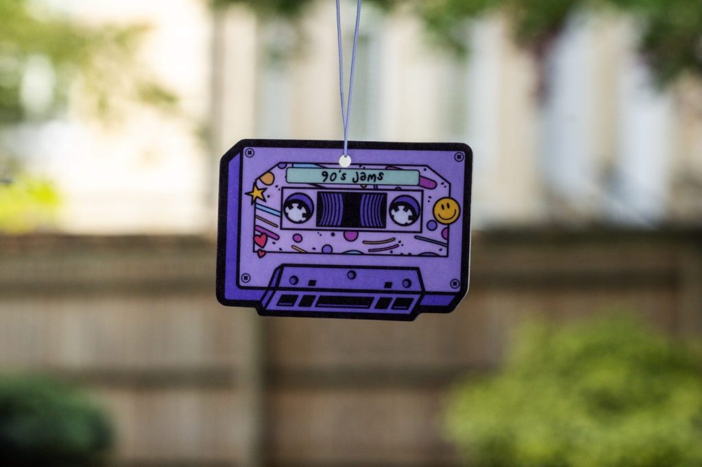 A Really?! air freshener shaped like a purple cassette tape